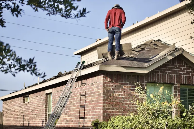 Professional roofer working on a residential roof in Oakwood at Plymouth